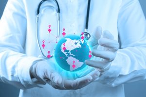 Medical Doctor holding a world globe in his hands as medical network as concept